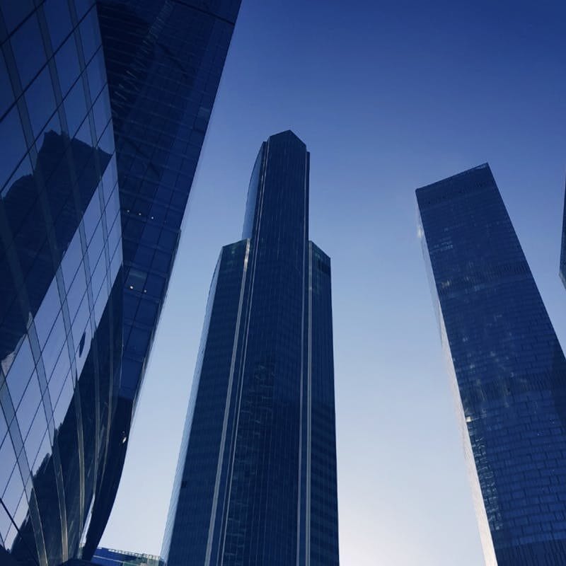 pexels-photo-2078774-2078774 Low angle view of modern skyscrapers in Moscow with a striking morning sun backdrop.